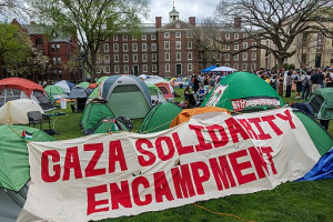 2024 Gaza Solidarity Encampment at Brown University 2024 Gaza Solidarity Encampment at Brown University, showing a tent encampment with a white panel and red letters reading "Gaza Solidarity Encampment"