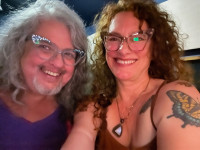 Ani Haines and Lisa Loving two women smiling in a radio airroom