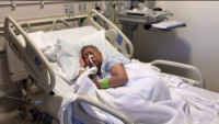 Helen Huynh in a hospital bed